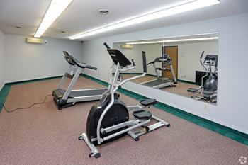 A treadmill and exercise equipment in the fitness room
